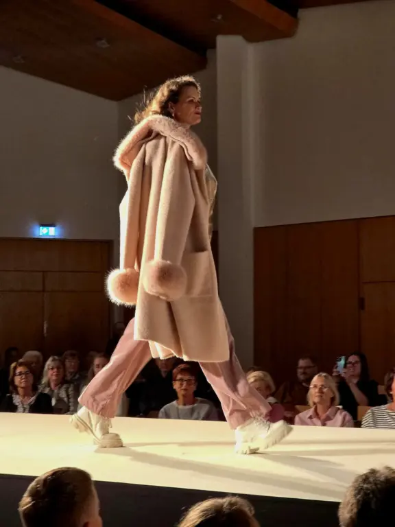 Model im rosa Mantel mit Kapuze bei der Großen Echter Modenschau zur Kunstnacht in Murnau.